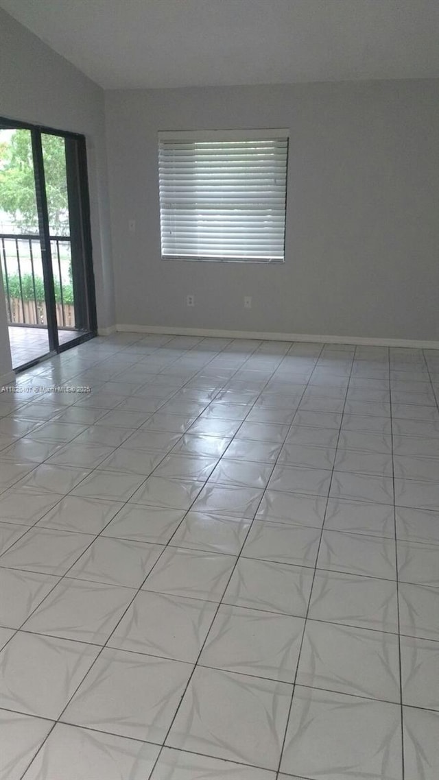 9810 Hammocks Blvd Unit 202, Miami, FL 33196 - spare room with baseboards and lofted ceiling
