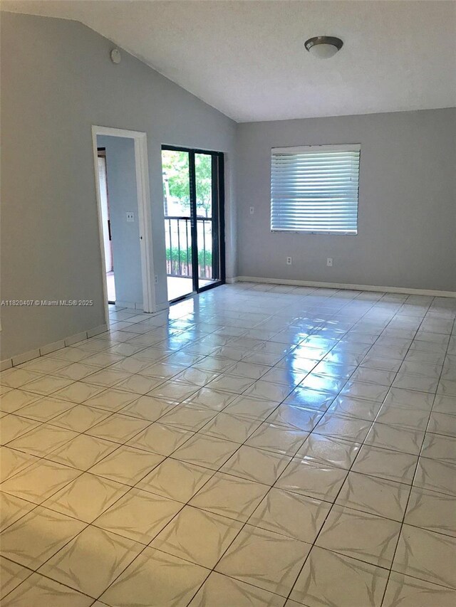 9810 Hammocks Blvd Unit 202, Miami, FL 33196 - spare room featuring lofted ceiling and a smoke detector
