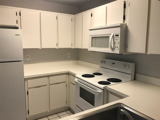 9810 Hammocks Blvd Unit 202, Miami, FL 33196 - kitchen featuring white appliances, light countertops, and light tile patterned floors