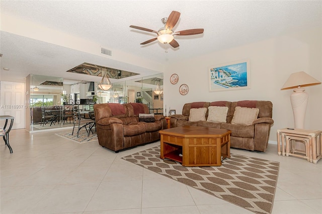 240 Captains Walk Unit 5110, Delray Beach, FL 33483 - living room featuring a textured ceiling, light tile patterned floors, and a ceiling fan