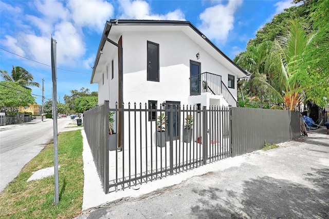 1805 SW 4th St, Miami, FL 33135 - view of front of property featuring a fenced front yard, stucco siding, a gate, and a balcony
