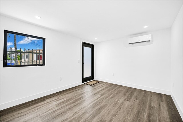 1805 SW 4th St, Miami, FL 33135 - empty room featuring a wall mounted AC, wood finished floors, and recessed lighting