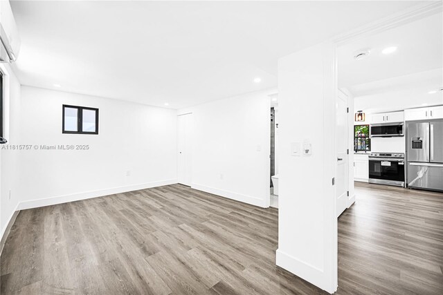1805 SW 4th St, Miami, FL 33135 - empty room with wood finished floors, recessed lighting, and a wall mounted air conditioner