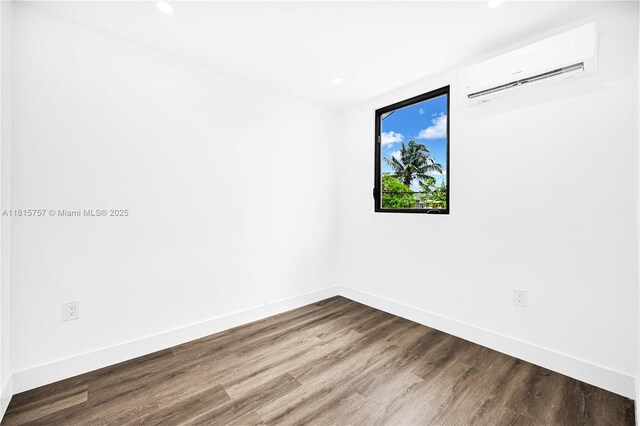1805 SW 4th St, Miami, FL 33135 - empty room featuring a wall unit AC, recessed lighting, and wood finished floors