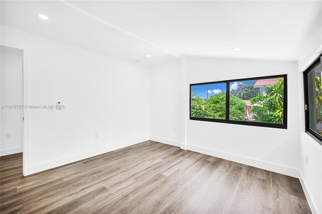 1805 SW 4th St, Miami, FL 33135 - unfurnished room featuring vaulted ceiling, wood finished floors, and recessed lighting