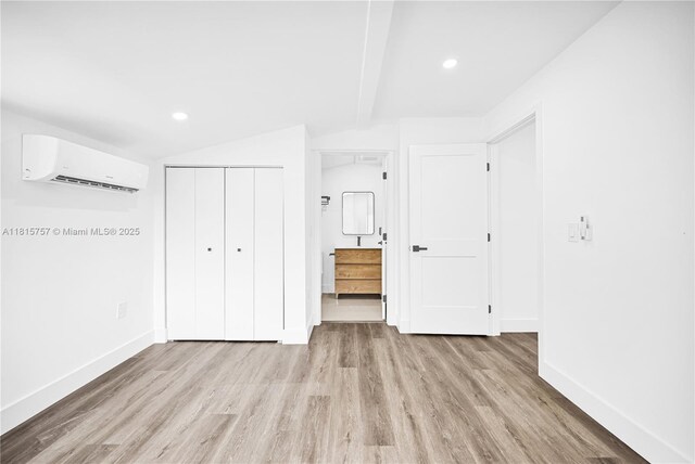 1805 SW 4th St, Miami, FL 33135 - unfurnished bedroom with a wall unit AC, light wood-style floors, lofted ceiling, a closet, and recessed lighting