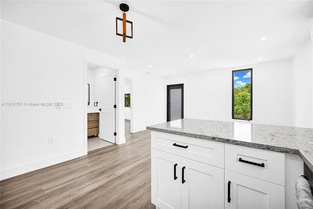 1805 SW 4th St, Miami, FL 33135 - kitchen featuring light wood finished floors, white cabinetry, light stone counters, and recessed lighting