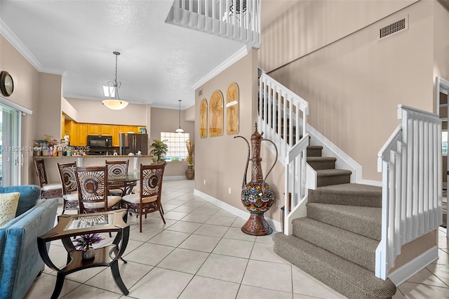 1762 E Trafalgar Cir, Hollywood, FL 33020 - entrance foyer featuring crown molding, light tile patterned floors, and stairs