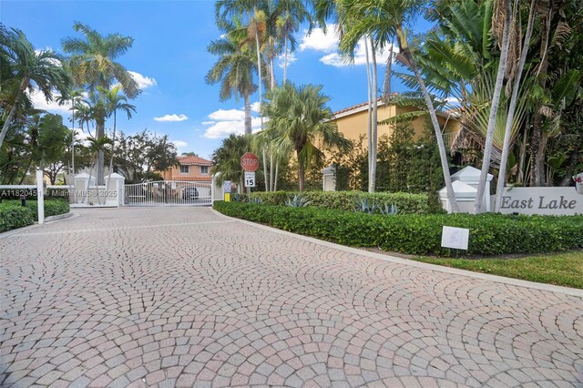 1762 E Trafalgar Cir, Hollywood, FL 33020 - view of street with a gate, traffic signs, a gated entry, and curbs