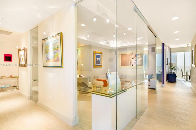 9705 Collins Ave Unit 1101N, Bal Harbour, FL 33154 - hallway featuring light wood finished floors and track lighting