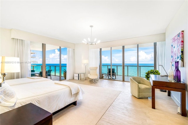 9705 Collins Ave Unit 1101N, Bal Harbour, FL 33154 - bedroom featuring access to exterior, a chandelier, and a water view