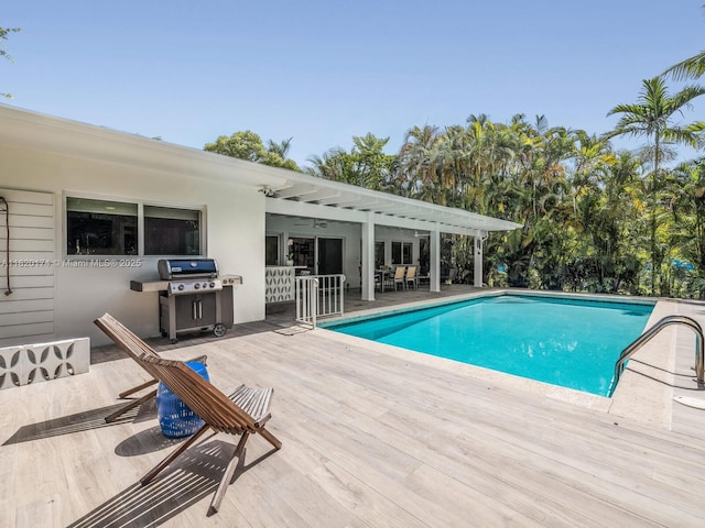 1130 NE 91st Ter, Miami Shores, FL 33138 - swimming pool featuring area for grilling, a deck, and outdoor dining space