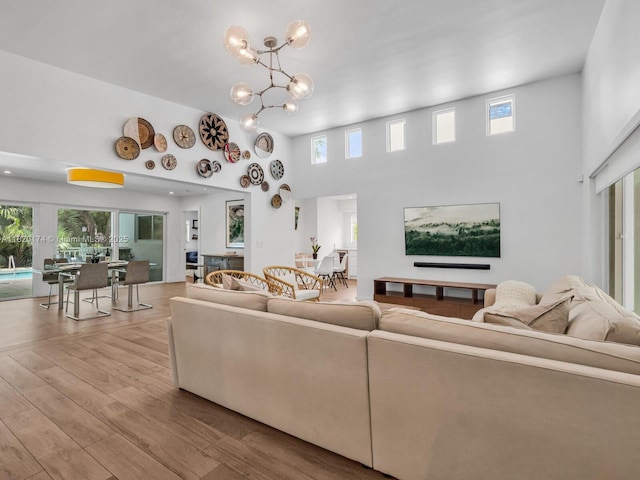 1130 NE 91st Ter, Miami Shores, FL 33138 - living area featuring a high ceiling, wood finished floors, and a chandelier