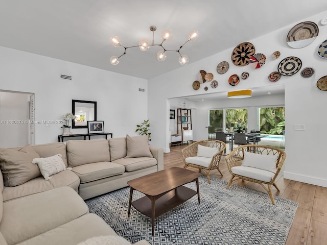 1130 NE 91st Ter, Miami Shores, FL 33138 - living room featuring light wood-style floors and a chandelier