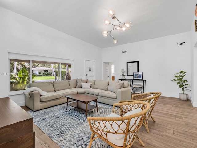 1130 NE 91st Ter, Miami Shores, FL 33138 - living room with a chandelier and light wood-type flooring