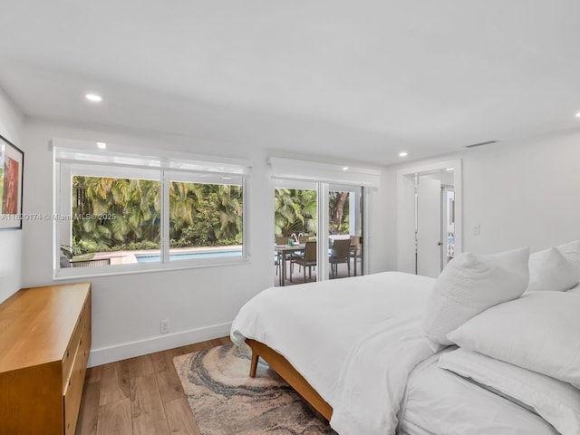 1130 NE 91st Ter, Miami Shores, FL 33138 - bedroom featuring wood finished floors, recessed lighting, and access to exterior