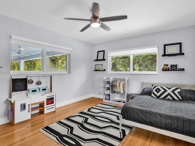 1130 NE 91st Ter, Miami Shores, FL 33138 - bedroom with multiple windows, light wood-style flooring, and ceiling fan