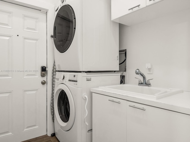 1130 NE 91st Ter, Miami Shores, FL 33138 - washroom featuring estacked washer and dryer, cabinet space, and wood finished floors