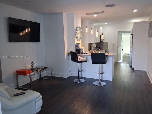 636 E 18th St, Hialeah, FL 33013 - living area with dark wood-style floors and recessed lighting