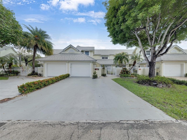 9933 NW 49th Ter, Doral, FL 33178 - view of front of property with a garage, driveway, and a gate