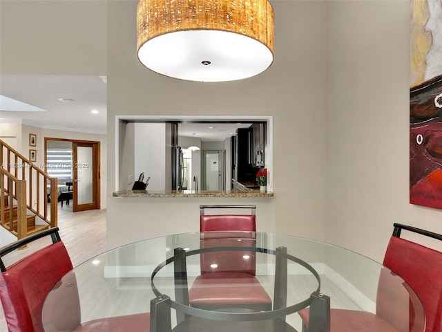 9933 NW 49th Ter, Doral, FL 33178 - dining space featuring stairs, a towering ceiling, ornamental molding, wood finished floors, and recessed lighting