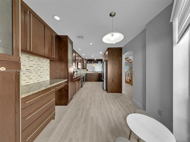 9933 NW 49th Ter, Doral, FL 33178 - kitchen featuring stainless steel appliances, light wood-type flooring, tasteful backsplash, light stone counters, and recessed lighting