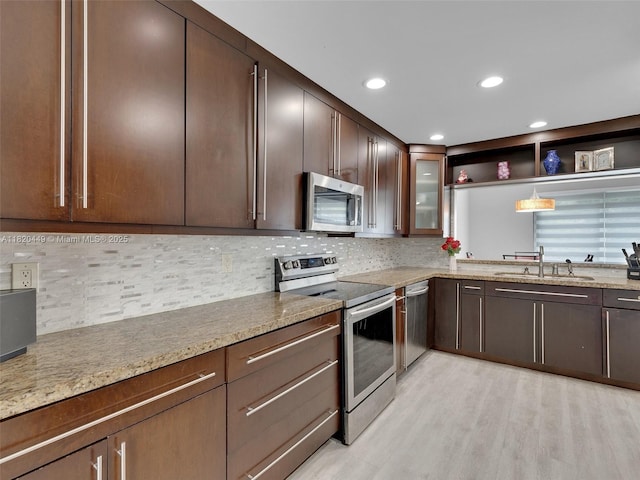 9933 NW 49th Ter, Doral, FL 33178 - kitchen with stainless steel appliances, decorative backsplash, light stone countertops, dark brown cabinetry, and recessed lighting