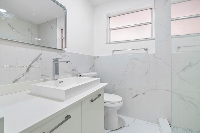 215 SE 3rd Ave Unit 303B, Hallandale Beach, FL 33009 - full bath featuring tile walls, vanity, a marble finish shower, and wainscoting