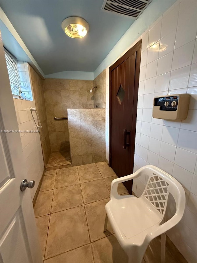 215 SE 3rd Ave Unit 303B, Hallandale Beach, FL 33009 - bathroom with tile walls, a walk in shower, and tile patterned floors