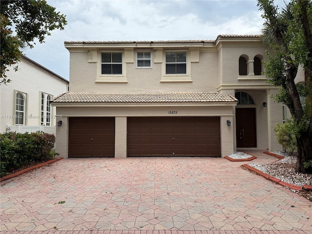 15875 SW 52nd St, Miramar, FL 33027 - view of front of home with an attached garage, stucco siding, decorative driveway, and a tile roof