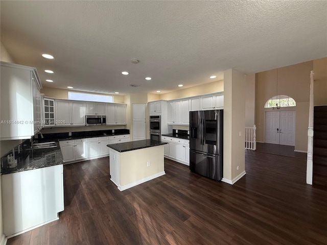 15875 SW 52nd St, Miramar, FL 33027 - kitchen featuring stainless steel appliances, dark wood-type flooring, a center island, glass insert cabinets, and recessed lighting