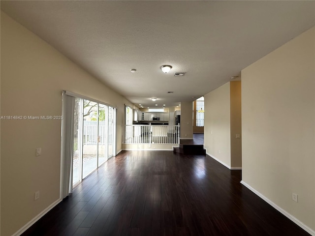15875 SW 52nd St, Miramar, FL 33027 - unfurnished living room featuring dark wood finished floors and a textured ceiling