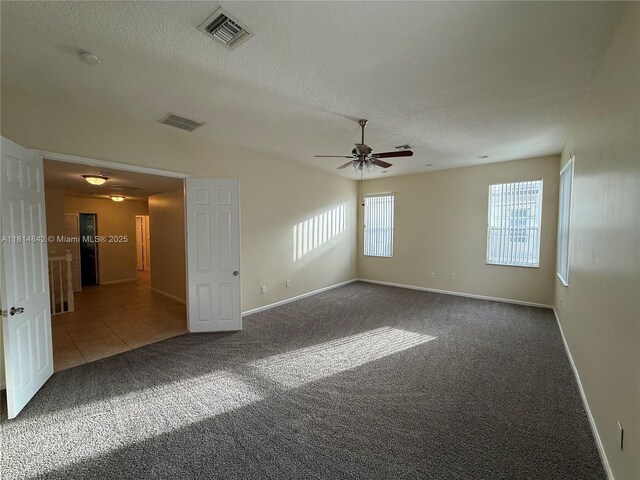 15875 SW 52nd St, Miramar, FL 33027 - carpeted empty room featuring ceiling fan, a textured ceiling, a smoke detector, and tile patterned flooring