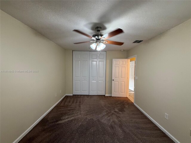 15875 SW 52nd St, Miramar, FL 33027 - unfurnished bedroom with dark colored carpet, a textured ceiling, a closet, and ceiling fan