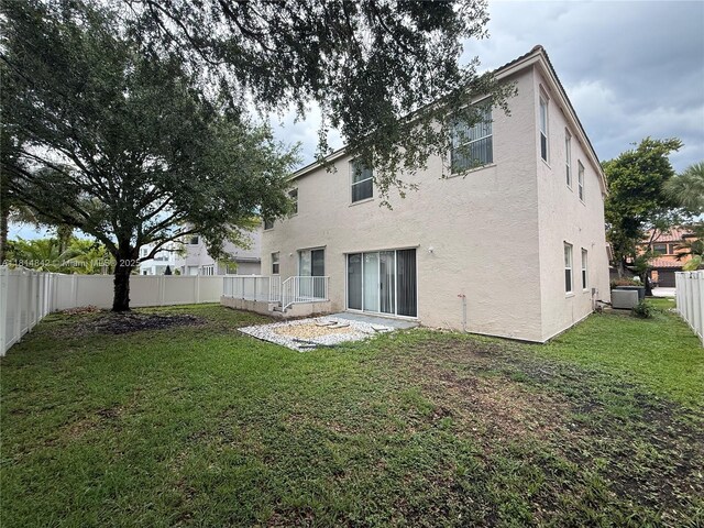 15875 SW 52nd St, Miramar, FL 33027 - rear view of property with stucco siding and a fenced backyard