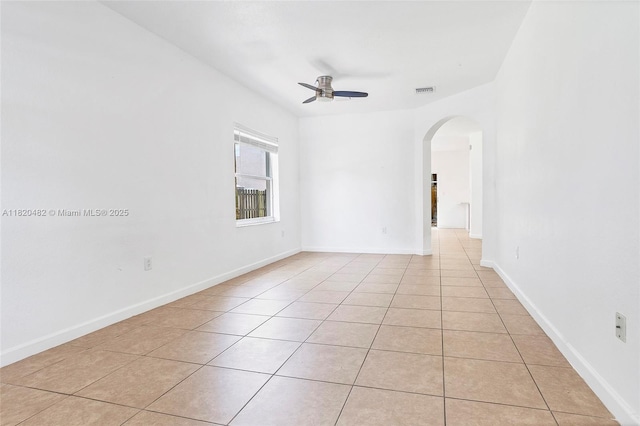 22569 SW 89th Pl, Cutler Bay, FL 33190 - empty room featuring arched walkways, light tile patterned floors, and a ceiling fan