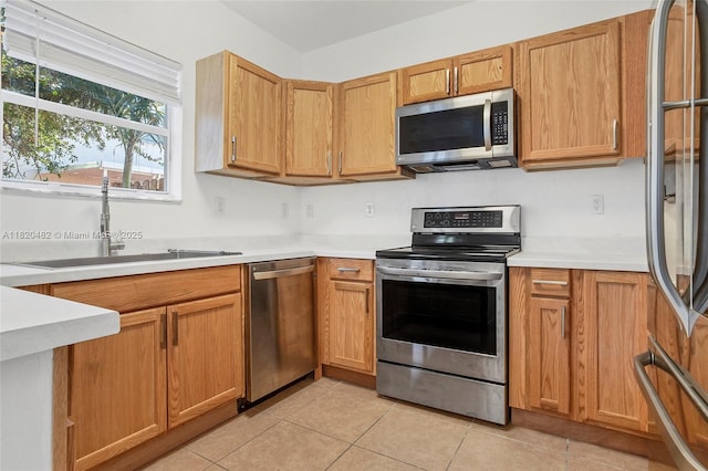 22569 SW 89th Pl, Cutler Bay, FL 33190 - kitchen with stainless steel appliances, light tile patterned flooring, and light countertops