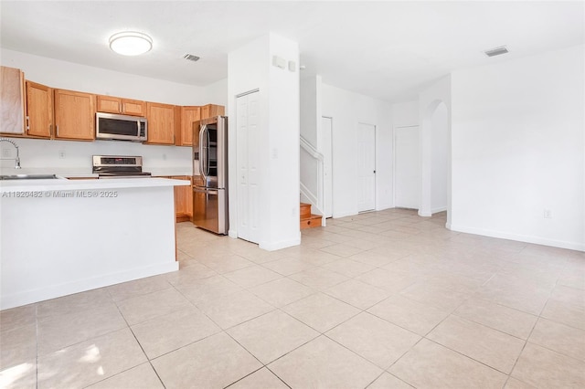 22569 SW 89th Pl, Cutler Bay, FL 33190 - kitchen with stainless steel appliances, light countertops, and light tile patterned floors