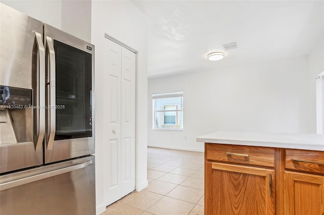 22569 SW 89th Pl, Cutler Bay, FL 33190 - kitchen with stainless steel fridge, light tile patterned flooring, light countertops, and brown cabinets