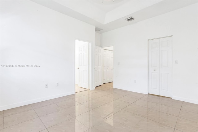 22569 SW 89th Pl, Cutler Bay, FL 33190 - unfurnished bedroom with multiple closets, light tile patterned floors, and a high ceiling