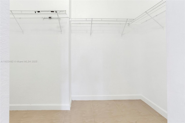 22569 SW 89th Pl, Cutler Bay, FL 33190 - spacious closet featuring light tile patterned floors