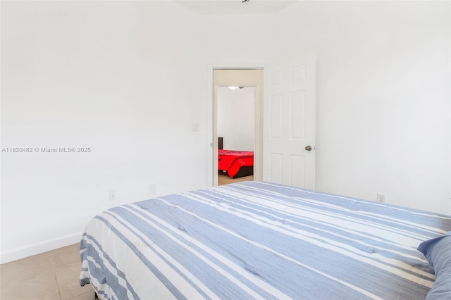 22569 SW 89th Pl, Cutler Bay, FL 33190 - bedroom with light tile patterned floors and baseboards