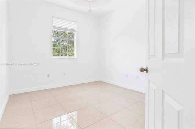 22569 SW 89th Pl, Cutler Bay, FL 33190 - spare room featuring baseboards and light tile patterned flooring