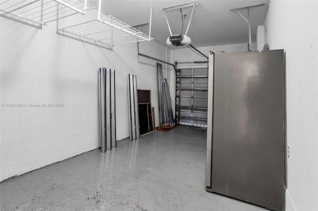 22569 SW 89th Pl, Cutler Bay, FL 33190 - garage featuring a garage door opener and freestanding refrigerator