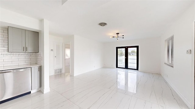 220 SW 8th Ave, Hallandale Beach, FL 33009 - unfurnished living room featuring light marble finish flooring and french doors