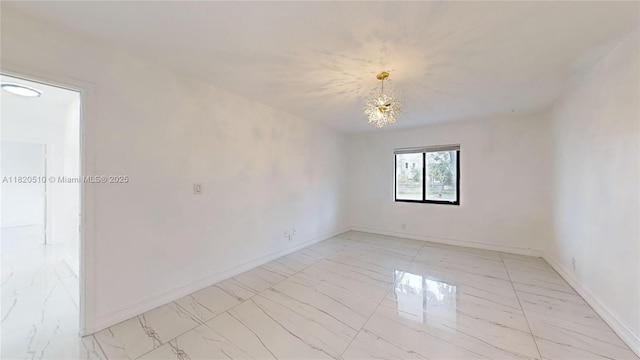 220 SW 8th Ave, Hallandale Beach, FL 33009 - spare room featuring light marble finish floors and a chandelier