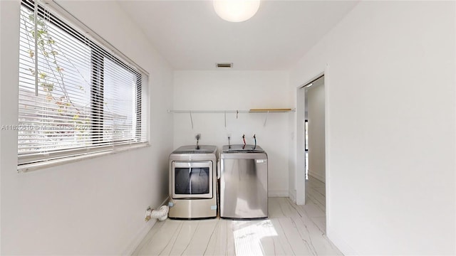 220 SW 8th Ave, Hallandale Beach, FL 33009 - washroom with independent washer and dryer and marble look tile flooring