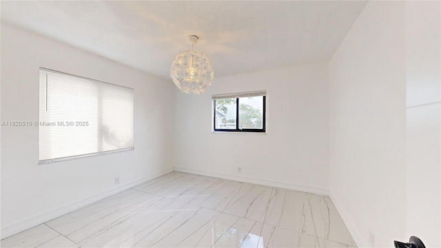 220 SW 8th Ave, Hallandale Beach, FL 33009 - unfurnished room with light marble finish floors and a chandelier