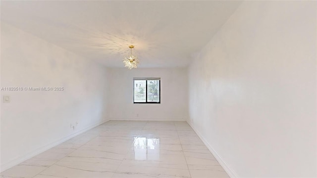 220 SW 8th Ave, Hallandale Beach, FL 33009 - empty room featuring a chandelier and light marble finish flooring