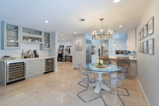 11900 SW 72nd Pl, Pinecrest, FL 33156 - dining room featuring beverage cooler, bar, a chandelier, recessed lighting, and light tile patterned floors
